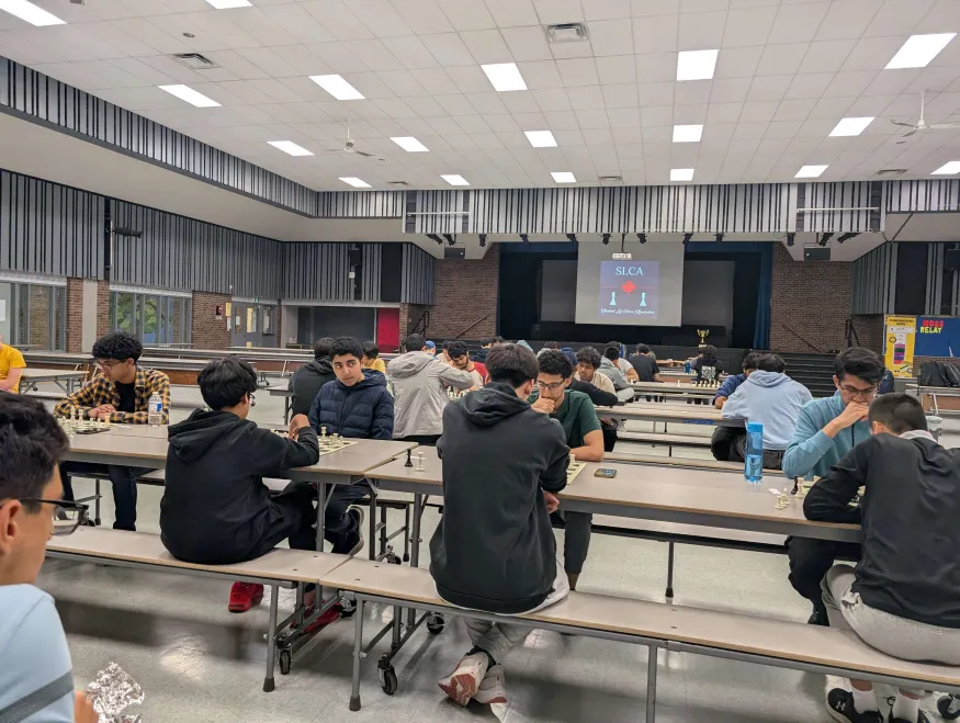 2 highschool chess players shaking hands after a tense chess game